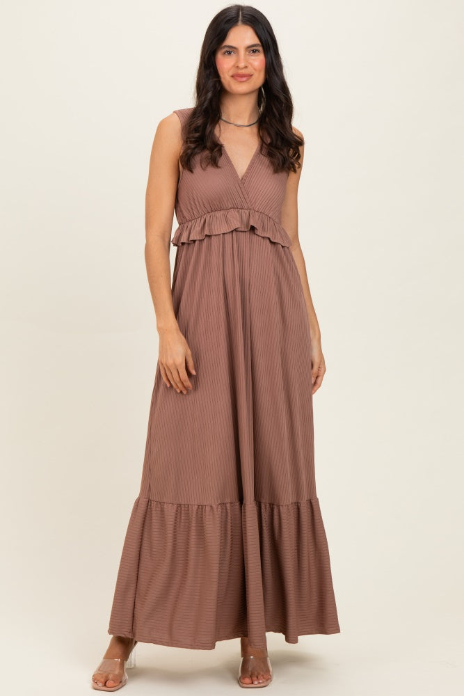 woman wearing a brown sleeveless maxi dress with a ruffled waist and flared hem