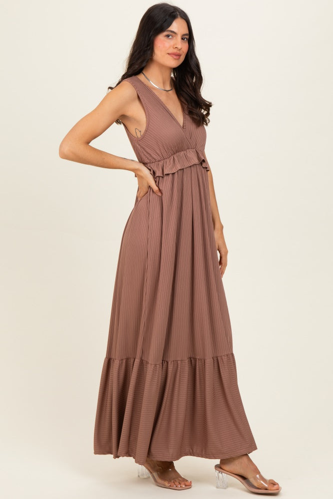 woman wearing a dusty rose sleeveless maxi dress with a tiered skirt and a fitted bodice
