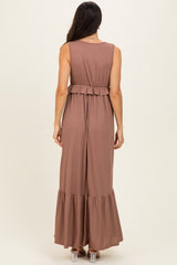 woman wearing a brown ribbed maxi dress with a tiered ruffle hem and a cinched waist, shown from the back
