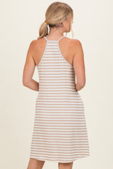 woman wearing a beige and white striped sleeveless dress with a relaxed fit