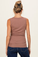 woman wearing a mauve sleeveless ribbed maternity top, showing the back view with a fitted silhouette