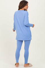 woman wearing a light blue maternity tunic top and matching leggings, showing a relaxed fit from the back