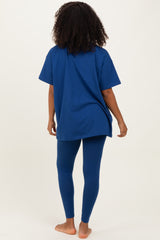 woman wearing a navy blue oversized t-shirt and matching leggings, seen from the back