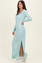 woman wearing a mint green long sleeve ribbed maxi dress with a side slit and white sneakers
