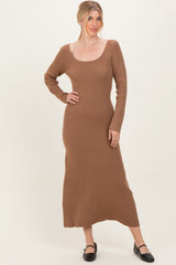 woman wearing a brown ribbed long sleeve midi dress with a scooped neckline and a fitted silhouette