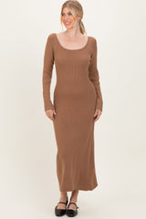 woman wearing a camel ribbed long sleeve maxi dress with a scoop neckline and a fitted silhouette