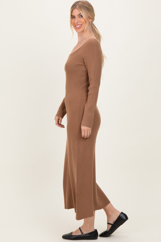 woman wearing a ribbed brown midi dress with a v-neck and side slits, styled with black flats