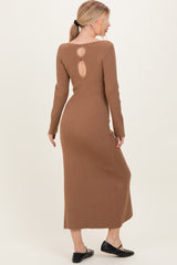 woman wearing a brown ribbed long sleeve maxi dress with a keyhole back detail and black flat shoes