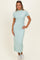 woman wearing a light mint green ribbed maxi dress with short sleeves and a high neckline