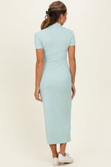 woman wearing a mint green ribbed midi dress with short sleeves, seen from the back, paired with white sneakers