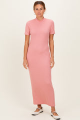 woman wearing a pink ribbed maxi dress with short sleeves and a fitted silhouette