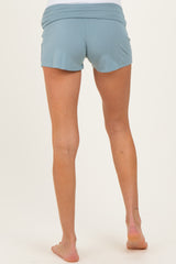 woman wearing light blue maternity shorts, viewed from the back