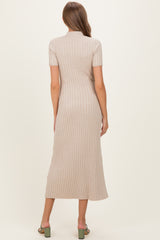 woman wearing a beige ribbed midi maternity dress with a fitted silhouette and short sleeves