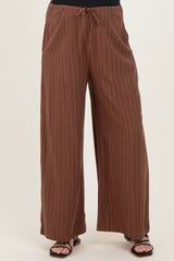 maternity wear brown striped wide-leg pants with an elastic waistband and tie detail, styled with a black top