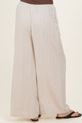 woman wearing light beige striped wide-leg pants with an elastic waistband and side pockets