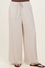 woman wearing beige striped wide-leg pants with an elastic waistband and drawstring detail