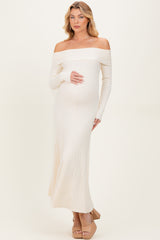 woman wearing an off-the-shoulder ribbed maternity dress in light beige, showcasing her baby bump