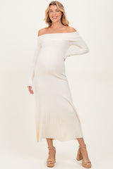 woman wearing a cream off-the-shoulder ribbed maternity dress with a side slit and a visible baby bump