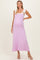 woman wearing a light purple maternity maxi dress with tie straps and a visible baby bump