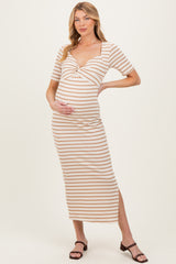 woman wearing a striped beige and brown maternity midi dress with a twist front and short sleeves, holding her baby bump