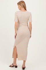 woman wearing a striped maternity maxi dress with short sleeves and a side slit, showing her baby bump