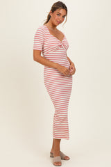 woman wearing a striped midi dress with short sleeves and a twist front detail, posing sideways