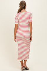 woman wearing a striped midi dress with half sleeves and a fitted silhouette, standing with her back to the camera