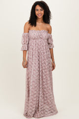 woman wearing a pink off-the-shoulder maxi dress with puff sleeves and floral pattern