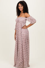 woman wearing a pink off-the-shoulder long floral maxi dress with ruffled sleeves