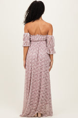 woman wearing a lavender off-the-shoulder maxi dress with puff sleeves and a floral pattern, seen from the back