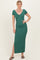 woman wearing a forest green ribbed maxi dress with short sleeves and a side slit, posing with one hand on her hip
