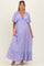 woman wearing a lavender maternity maxi dress with a tie front and tiered ruffles, showcasing her baby bump