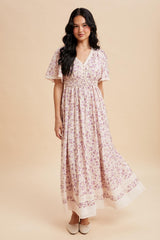 woman wearing a floral print maxi dress with short sleeves and a smocked waist
