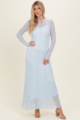 woman wearing a light blue long sleeve maxi dress with a lace overlay and a fitted silhouette
