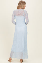 woman wearing a light blue lace long sleeve maxi dress with a fitted bodice and flowing skirt from the back