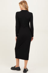 woman wearing a long sleeve black maternity dress with a midi length and a fitted silhouette from the back