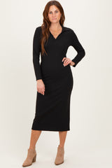 woman wearing a black ribbed long sleeve midi dress with a collared neckline and beige ankle boots