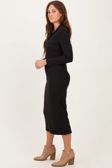 woman wearing a black ribbed long sleeve midi dress and tan ankle boots