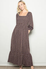 woman wearing a brown floral maxi dress with a square neckline and long puff sleeves