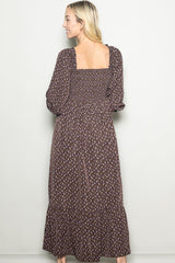 woman wearing a brown floral maxi dress with long sleeves and a square back design
