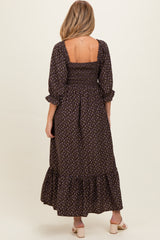 woman wearing a brown floral print maternity maxi dress with a smocked bodice and puff sleeves