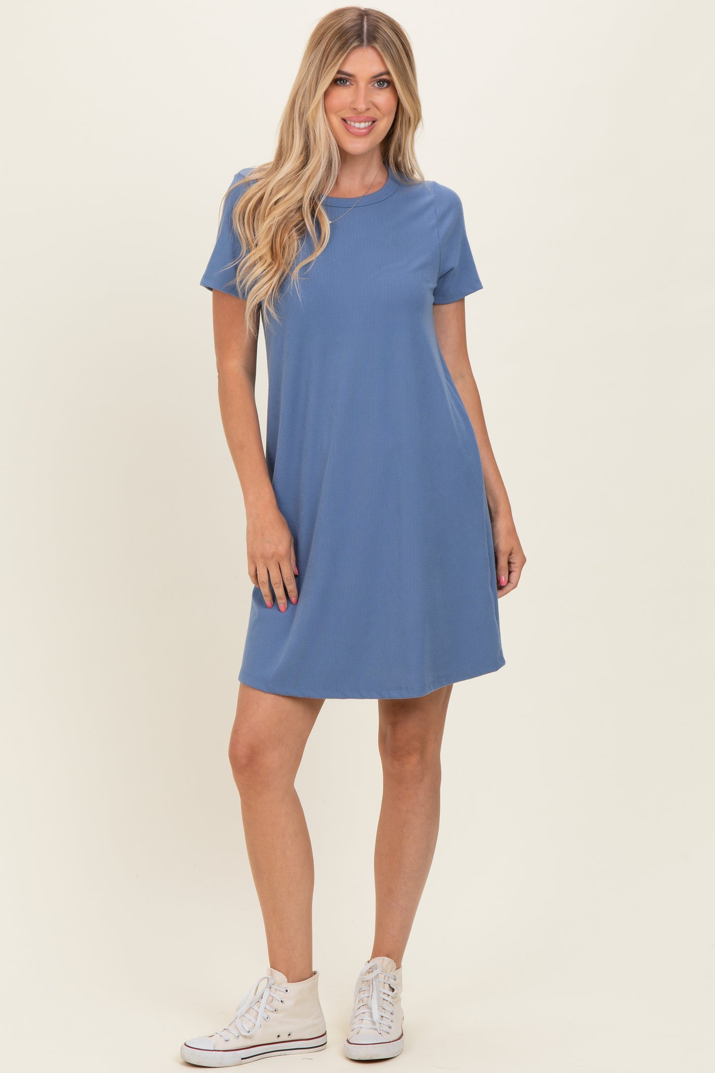 woman wearing a blue short sleeve ribbed dress with a relaxed fit and white sneakers