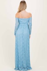woman wearing a light blue off-the-shoulder lace maxi dress with long sleeves