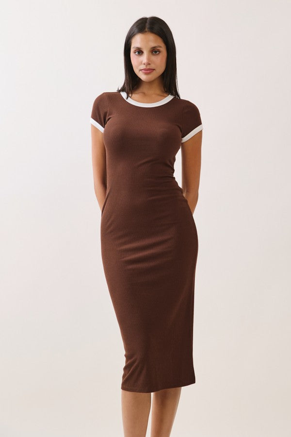 woman wearing a brown fitted midi dress with white trim on the sleeves