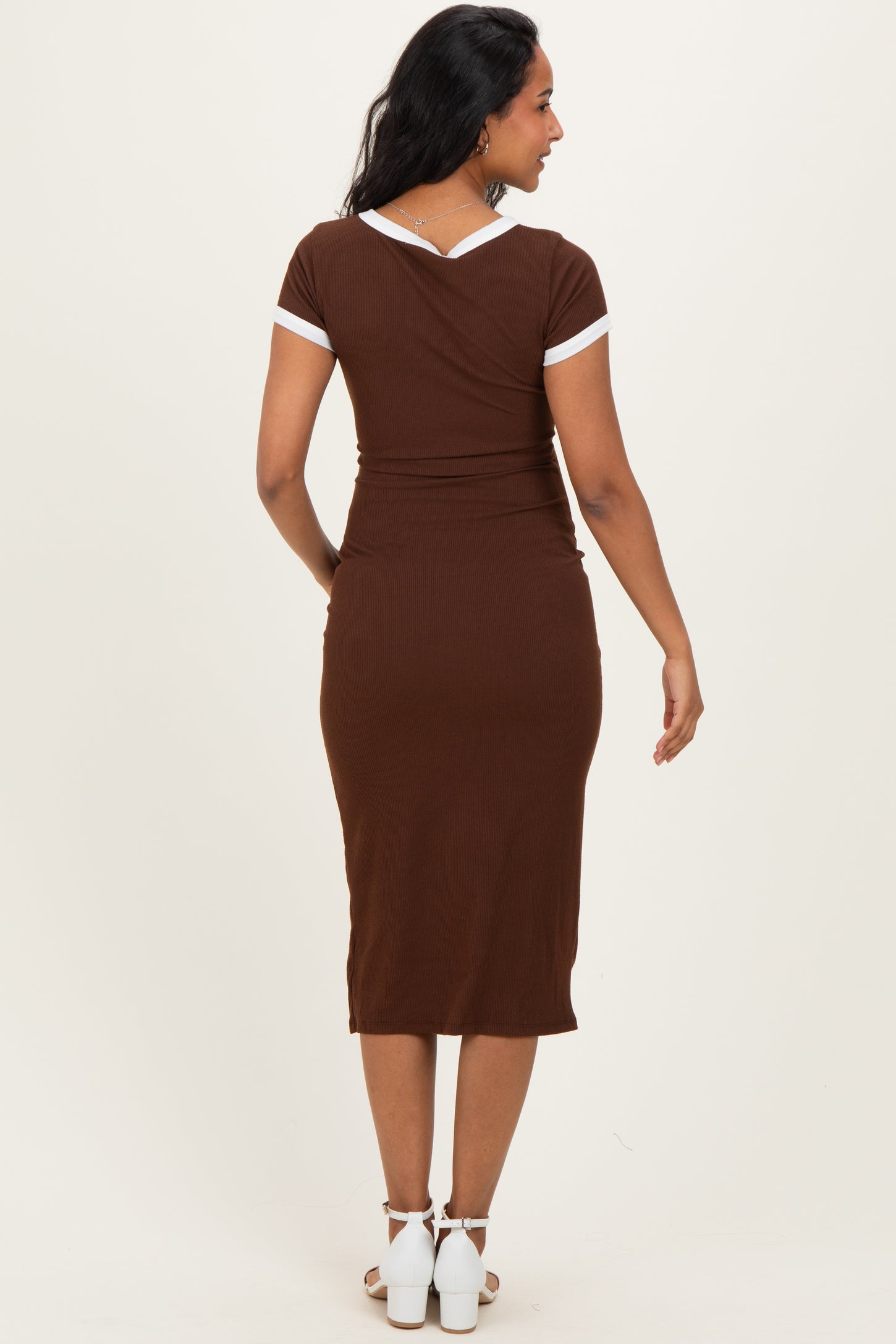 maternity wear brown ribbed dress with white trim details, worn by a model showing a baby bump from the back
