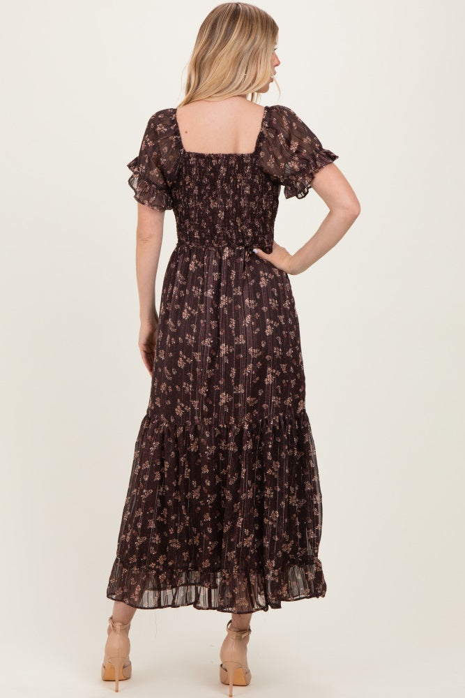 woman wearing a back view of a brown floral maxi dress with short ruffled sleeves and a smocked bodice