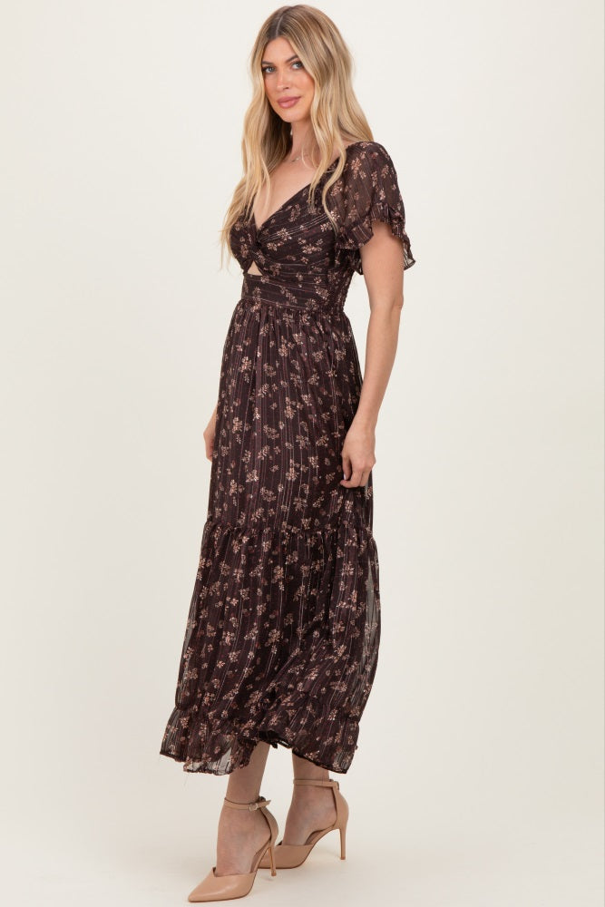 woman wearing a black floral maxi dress with short sleeves and a tiered skirt
