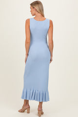 woman wearing a light blue ribbed maternity maxi dress with a ruffled hem