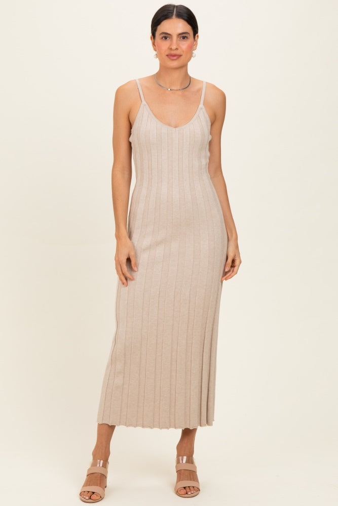 woman wearing a beige ribbed maxi dress with thin straps and a fitted silhouette