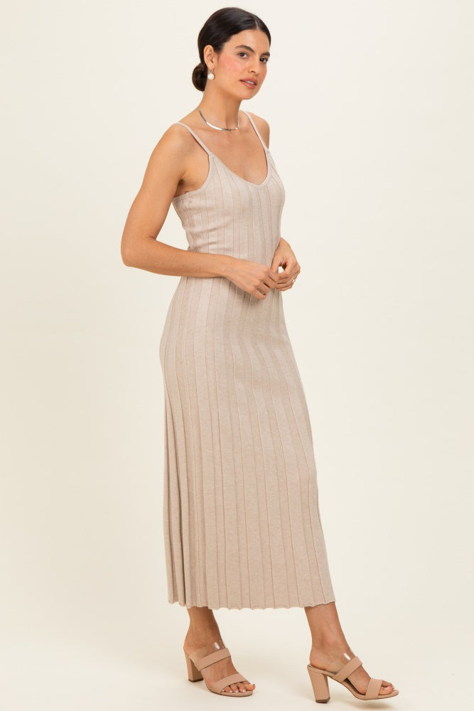 woman wearing a beige ribbed knit midi dress with spaghetti straps and a flattering silhouette